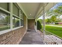 Covered front porch of a brick home with decorative railing at 9303 Leroy Rd, Brownsburg, IN 46112