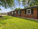 Lovely single-story brick home with black shutters and a meticulously maintained front lawn at 961 N Dellasburg Rd, Columbus, IN 47203