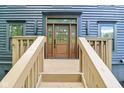 The front door of the home is a beautiful wooden door with a glass pane and a decorative frame at 10455 Courageous Dr, Indianapolis, IN 46236