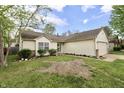 Charming single-story home with a two-car garage, well-maintained lawn, and lovely landscaping at 10688 Ashview Dr, Fishers, IN 46038