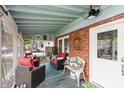 Inviting screened-in porch featuring comfortable seating and a ceiling fan, perfect for relaxing and entertaining at 116 High St, Brooklyn, IN 46111