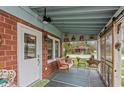 Relaxing screened porch with a cozy swing, comfortable seating, and a view of the surrounding neighborhood at 116 High St, Brooklyn, IN 46111