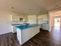Open concept kitchen with a large island, white cabinets, and modern recessed lighting at 1216 Mcbride St, Greenfield, IN 46140