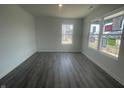Bright living room features hardwood flooring and large windows at 1216 Mcbride St, Greenfield, IN 46140