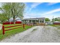 Exterior shot of the home, highlighting the yard, ramp and gravel driveway at 126 Brunswick Dr, Greenwood, IN 46143