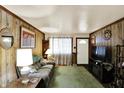 Cozy living room featuring wood paneling, plush seating, and a welcoming atmosphere at 126 Brunswick Dr, Greenwood, IN 46143
