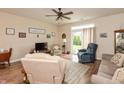 Cozy living room with a ceiling fan, comfortable seating, and sliding glass doors to the backyard at 131 Stamford Dr, Pittsboro, IN 46167