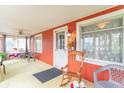 Cozy sunroom featuring ample light, casual seating, and an inviting rocking chair at 1633 E Thompson Rd, Indianapolis, IN 46227