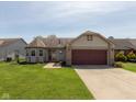 Traditional single-story home with brick accents, attached garage, and a well-maintained front lawn at 177 Tracy Ridge Blvd, Whiteland, IN 46184