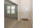 Welcoming foyer featuring wood-look floors and a bright white front door at 2006 Creek Bank Dr, Columbus, IN 47201