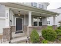 Inviting front porch with brick accents and charming lighting fixtures at 2006 Creek Bank Dr, Columbus, IN 47201