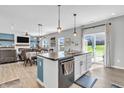 Open-concept kitchen with island seating that overlooks the living and dining areas with access to the backyard at 2261 Shadow Trace Way, Greenwood, IN 46143