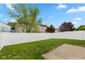 Large, fenced backyard with lush lawn and mature trees providing shade and privacy at 2623 Santaro Ct, Indianapolis, IN 46217