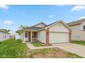 Charming single Gathering home with a brick facade, attached two-car garage and manicured lawn at 2623 Santaro Ct, Indianapolis, IN 46217