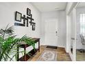 Bright entryway with wood floors, a decorative rug, console table, and a unique wall display at 2972 W Patchwork Dr, Monrovia, IN 46157