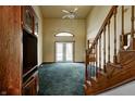 Spacious living room with high ceilings, a ceiling fan, carpet, and access to the backyard through glass doors at 305 Cardinal Dr, Whiteland, IN 46184