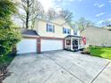 Two-story home with a brick-accented facade, an attached two-car garage, and an inviting front porch at 4223 Kestrel Ct, Indianapolis, IN 46254