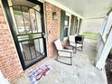 Cozy porch with rocking chairs, decorative welcome mat, and brick accents at 4223 Kestrel Ct, Indianapolis, IN 46254