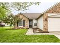 Attractive brick and siding home exterior with well kept lawn and appealing front door entry at 4303 Cowslip Ct, Indianapolis, IN 46203