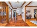 Spacious hallway with hardwood floors, detailed trim, and access to multiple rooms, enhancing the home's flow at 4401 W Hunters Ridge W Ln, Greenwood, IN 46143