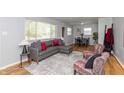 Bright living room with modern decor, hardwood floors, a comfortable couch, and natural light at 4468 N Elizabeth St, Indianapolis, IN 46226