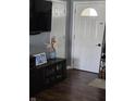 Inviting entryway featuring hardwood floors, modern decor, and a view of interior doors at 5218 Fletcher St, Anderson, IN 46013