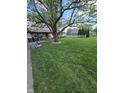 Well-manicured front yard with mature trees offering shade and curb appeal at 5218 Fletcher St, Anderson, IN 46013