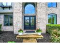 Inviting front entryway features a double door entry, updated landscaping and brick facade at 5255 Apache Moon, Carmel, IN 46033