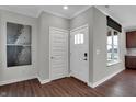 Inviting home foyer featuring a dark wood floor, neutral paint, and natural light at 5291 Nettleton Way, Avon, IN 46123