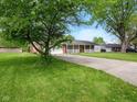 Ranch home with a covered front porch and long driveway at 5305 N Cork Dr, Muncie, IN 47304