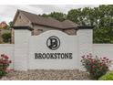 Brookstone neighborhood entrance featuring a brick sign and landscaping at 5499 Steven Dr, Greenwood, IN 46142