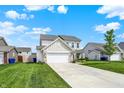 Spacious two-story home with a two-car garage and well-maintained lawn in a Gathering-friendly neighborhood at 5518 Wood Spring Ln, McCordsville, IN 46055