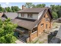 A brick two-story home with a covered front porch, offering a lovely view of the surroundings at 6051 Lowell Ave, Indianapolis, IN 46219