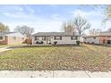 Attractive one-story home with a cozy porch and a well-maintained front yard filled with fallen leaves at 617 Grovewood Dr, Beech Grove, IN 46107