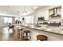 Bright condo kitchen with stainless steel appliances, white cabinets, and an island with barstool seating at 622 E 10Th St # 212, Indianapolis, IN 46202