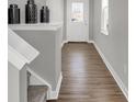 Inviting entryway featuring hardwood floors and stairway to the second floor at 7645 Marin Pkwy, Cumberland, IN 46229