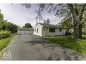 Traditional one-story home with attached two car garage, and paved driveway at 7702 Mary Ln, Indianapolis, IN 46217