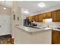 Kitchen with wooden cabinets, and a breakfast bar, offering both style and functionality at 8120 Glenwillow Ln # 206, Indianapolis, IN 46278
