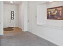 Welcoming entryway featuring light wood flooring, neutral carpet, and ample natural light at 8451 Sunningdale Blvd, Indianapolis, IN 46234