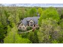 Gorgeous stone home with mature trees and lush landscaping in a serene setting at 9312 Sullivan Pl, Zionsville, IN 46077