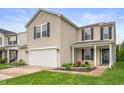 Charming two-story home boasts a two-car garage, driveway, well-kept lawn, and pleasant curb appeal at 9454 W Canoe Trl, Pendleton, IN 46064