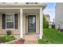 Inviting front porch features classic columns and a stylish storm door at 9454 W Canoe Trl, Pendleton, IN 46064