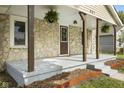 The home has a welcoming porch with wood supports, offering curb appeal to this cozy residence at 997 Yandes St, Franklin, IN 46131