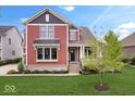 Inviting two-story home boasting a lush front lawn and charming curb appeal at 1013 Domino Dr, Carmel, IN 46032