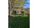 Expansive backyard featuring a wooden deck with pergola and mature trees, creating a private oasis at 11620 E 75Th St, Indianapolis, IN 46236