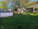 Spacious backyard with shed and mature trees, providing ample space for recreation and gardening at 11620 E 75Th St, Indianapolis, IN 46236