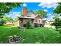 Charming two-story brick home with a manicured lawn and flower bed at 11620 E 75Th St, Indianapolis, IN 46236