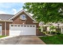 Beautiful brick home features a white garage door, green shutter, and cozy front porch at 12092 Sugar Creek Rd, Noblesville, IN 46060