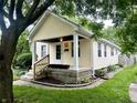Lovely single-Gathering home featuring mature trees and an inviting covered front porch at 1309 N Colorado Ave, Indianapolis, IN 46201