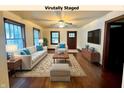 Staged living room featuring ample lighting, stylish décor, and hardwood floors at 1309 N Colorado Ave, Indianapolis, IN 46201